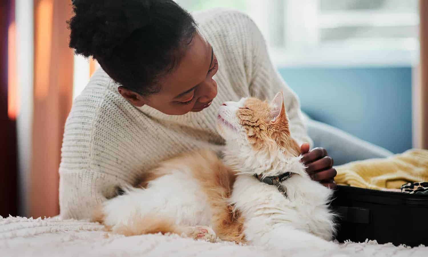 Woman snuggling with her cat